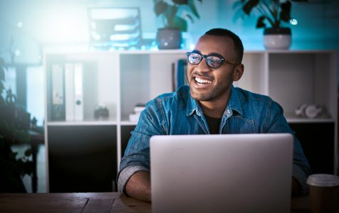 Shot of a young designer working late on a laptop in an office